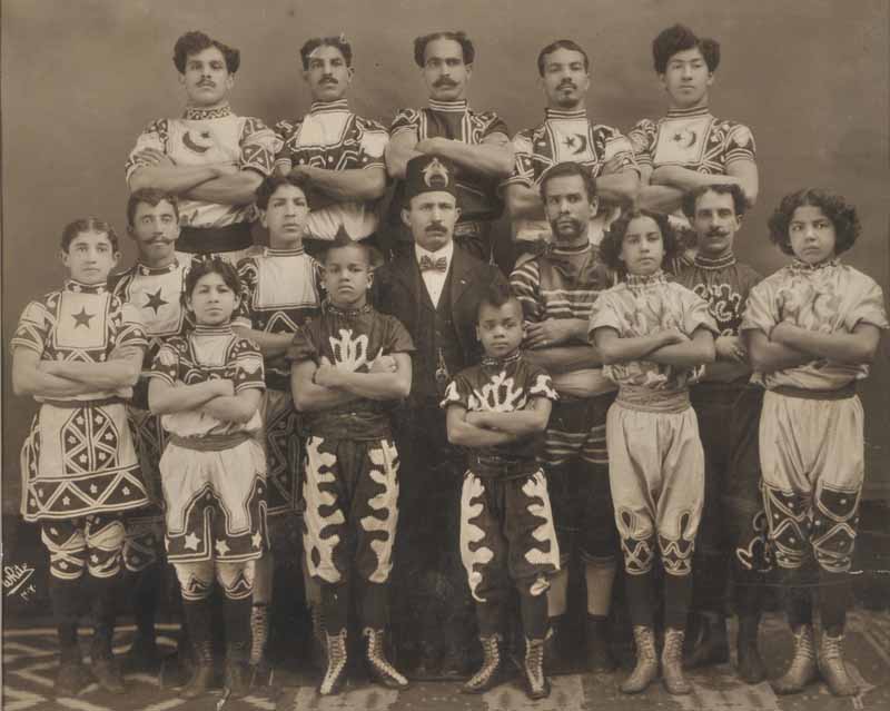 Sixteen circus performers, men and children. Image © The Harry Ransom Center, University of Texas, Austin